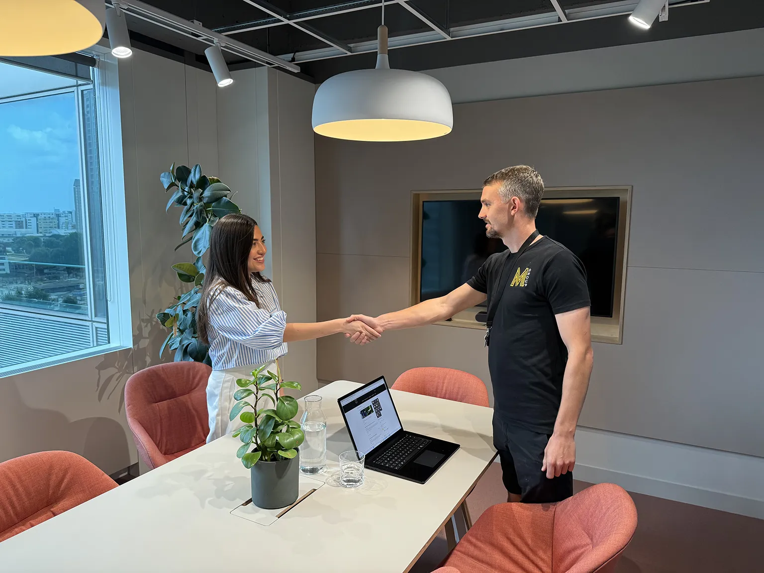 Hand shake between master care and emplyeee in meeting room